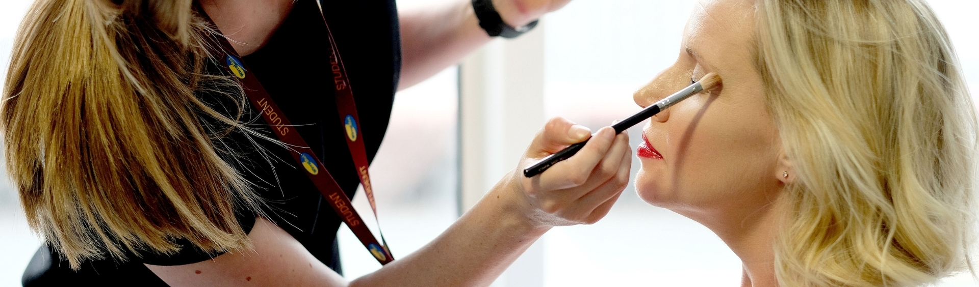 WMC Make-Up student working on customer inside classroom