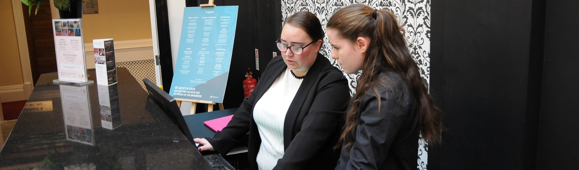 Two WMC Supported Interns working inside hotel