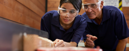 Apprentice in workshop with employer