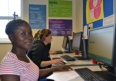 Three English And Maths Students Sat At Computers In Classroom