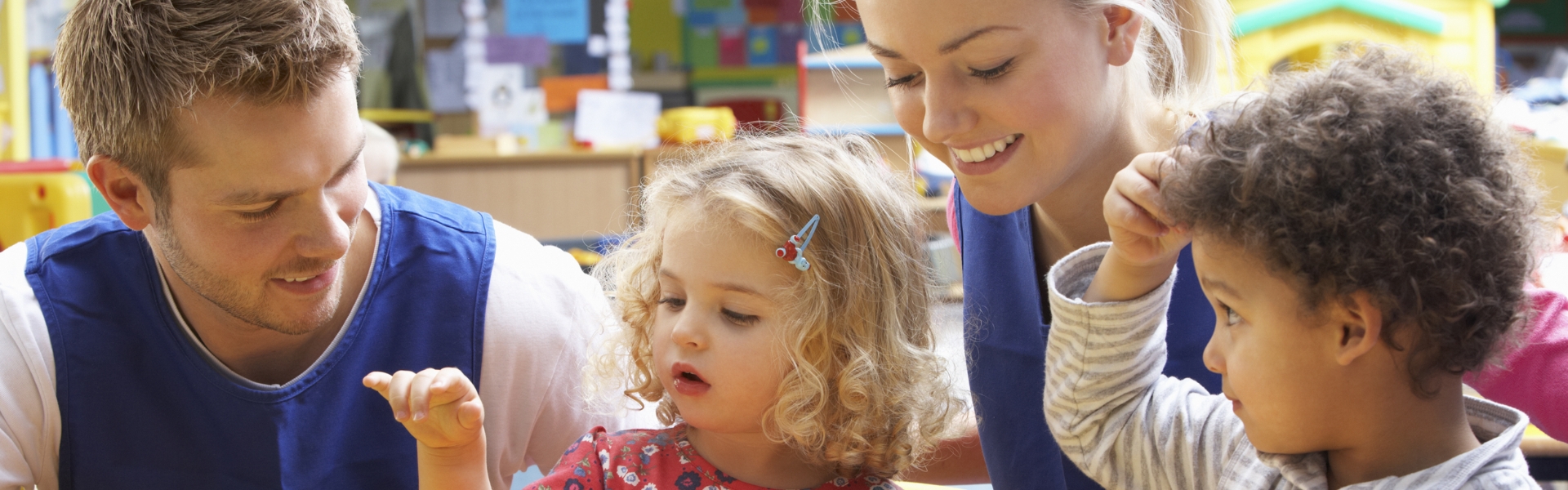 Two Childcare students working inside of nursery. 