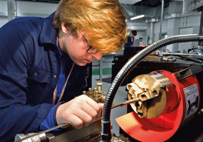 Male Engineering student Working In Workshop