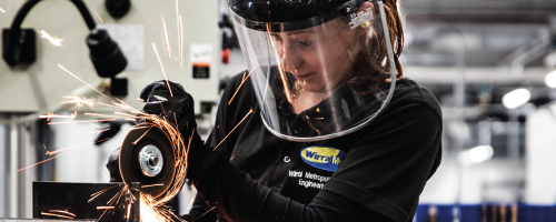 Mechanical Engineering Student working wearing black Wirral Met clothing